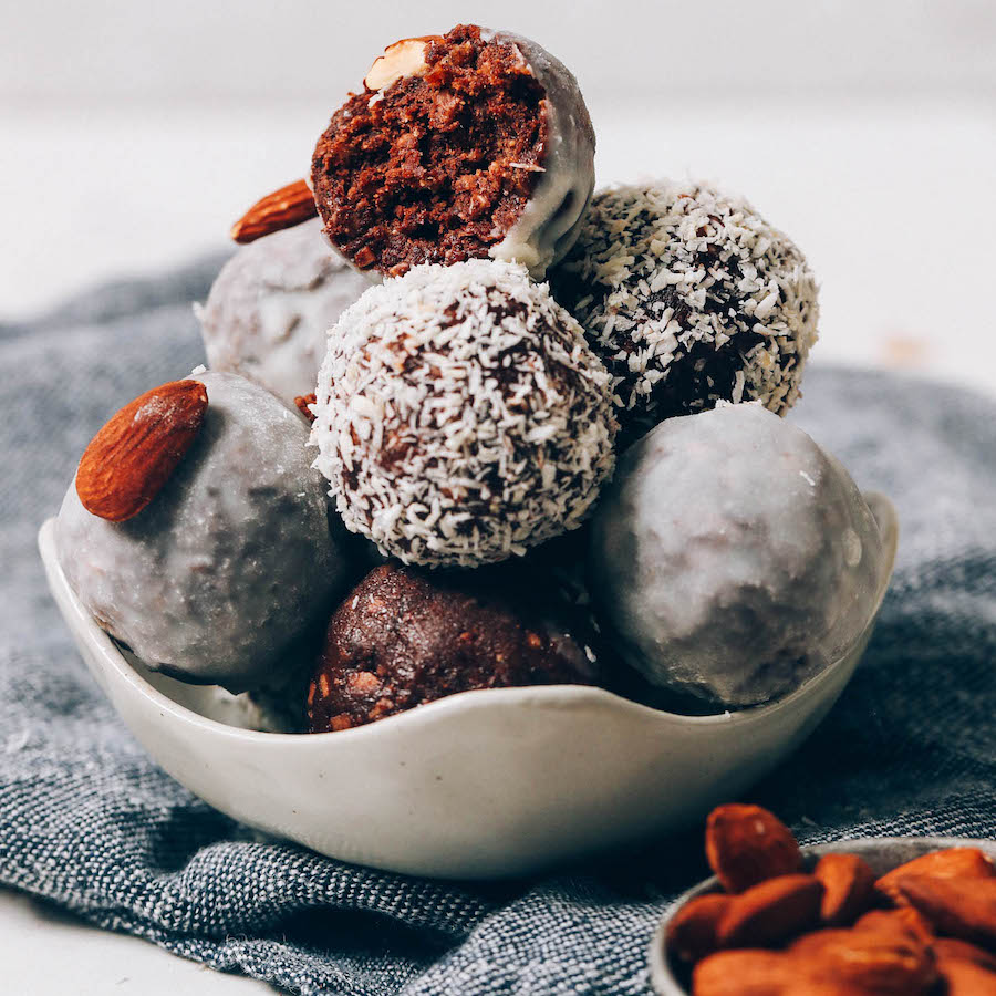 Bowl of Almond Joy Energy Bites coated in shredded coconut or coconut butter glaze