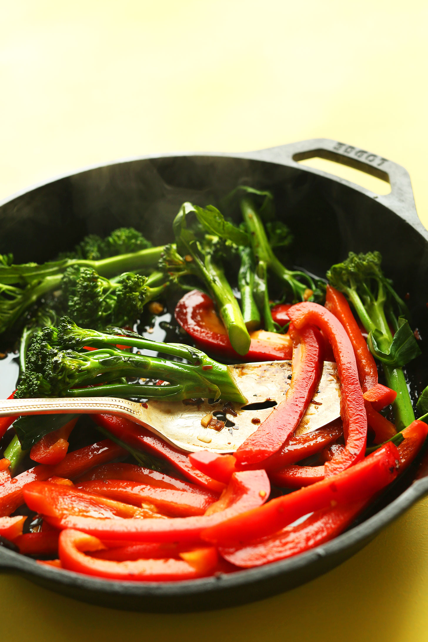 Cooking bell peppers and broccolini for a healthy vegan stir fry