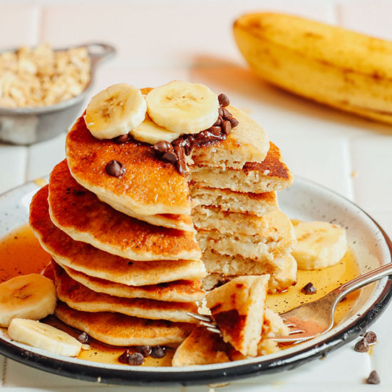 Stack of Banana Oat Pancakes with a slice removed