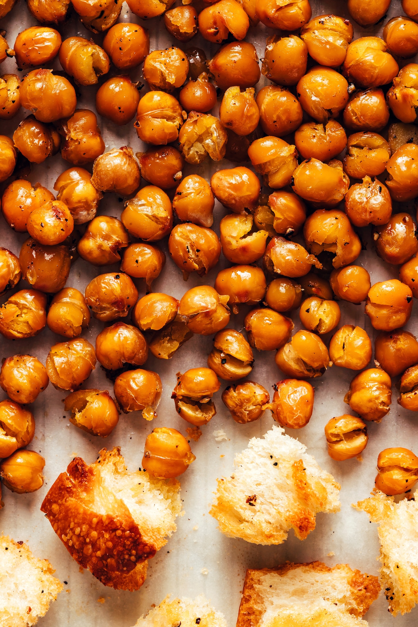 Close up photo of crispy chickpeas and homemade croutons on a baking sheet