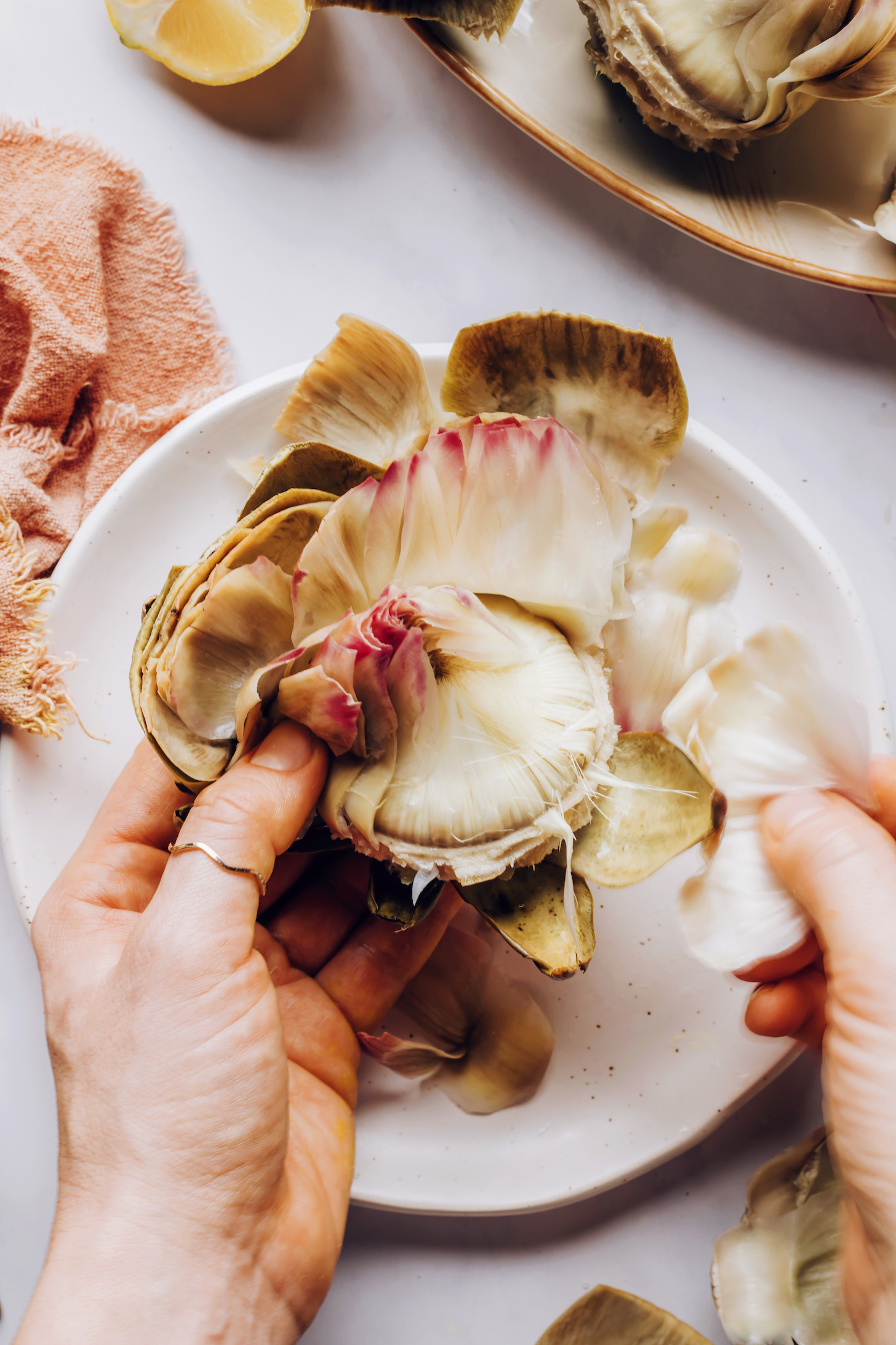 Peeling the petals around an artichoke heart