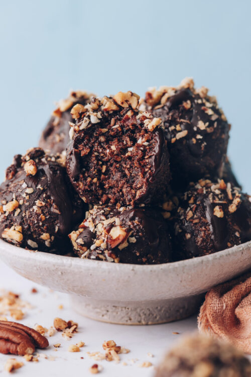 Bowl of German chocolate cake energy bites with one partially eaten