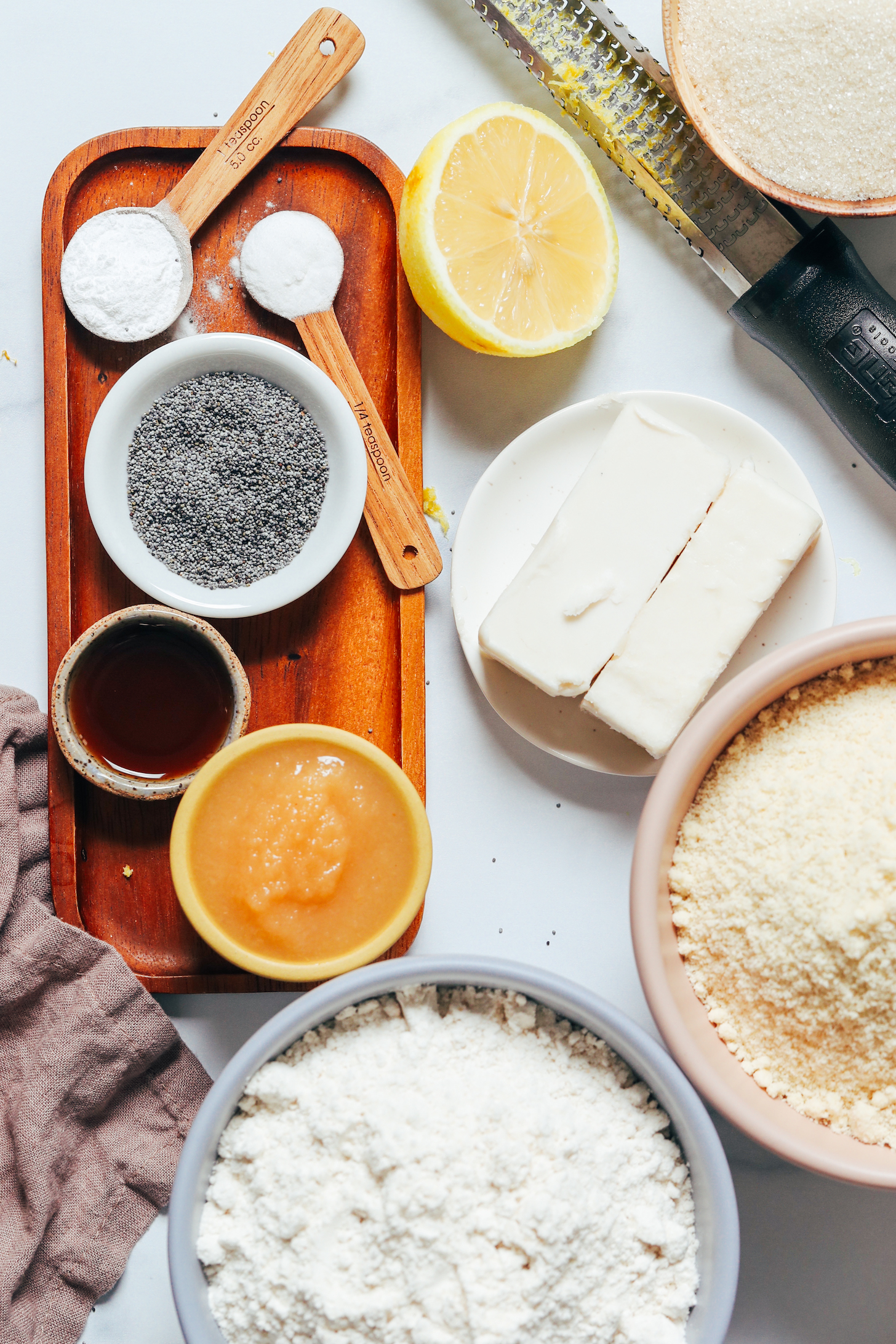 Almond flour, gluten-free flour blend, vegan butter, lemon, cane sugar, baking soda and powder, poppy seeds, applesauce, and vanilla