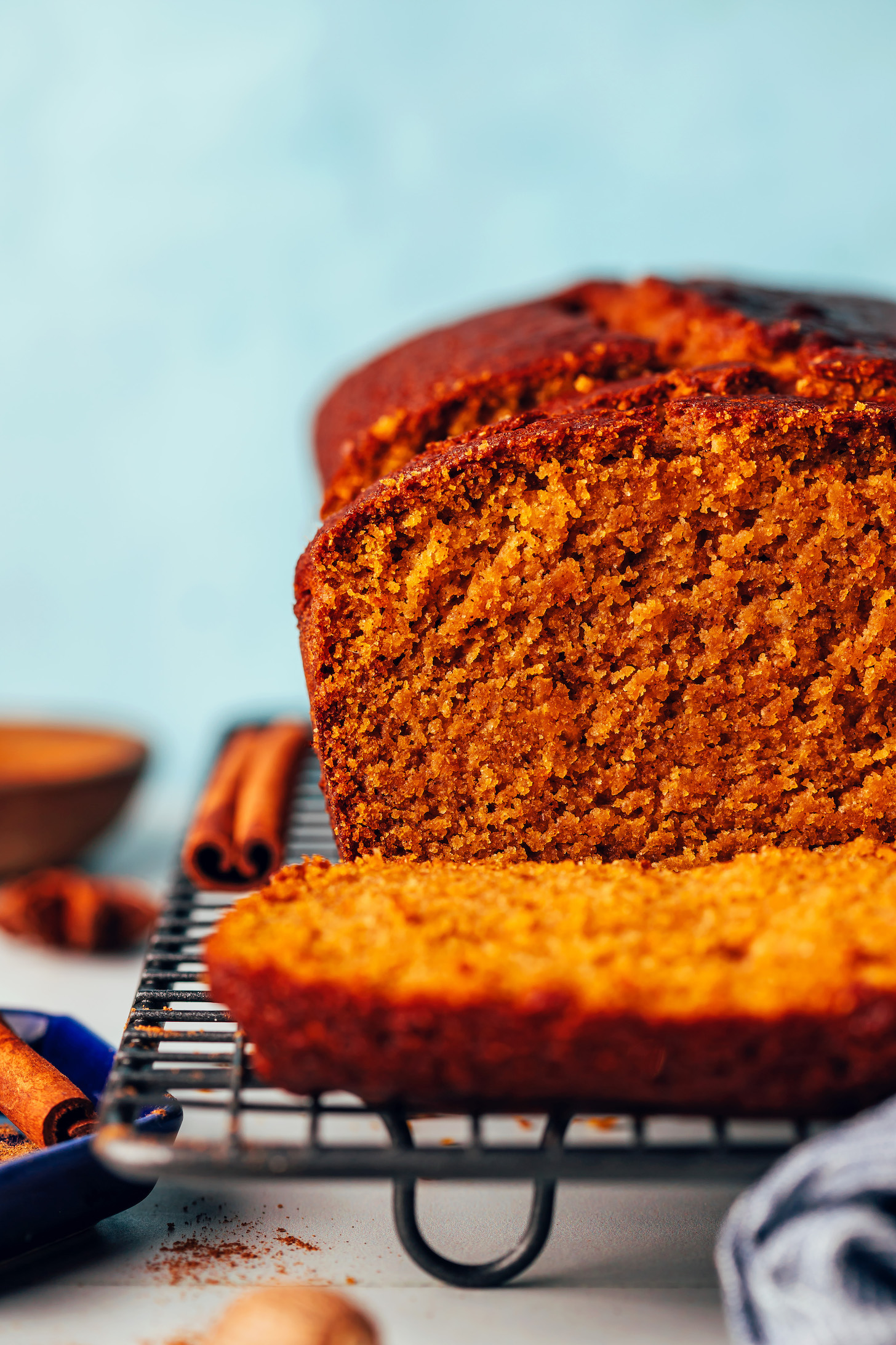 Sliced loaf of gluten-free pumpkin bread on a cooling rack