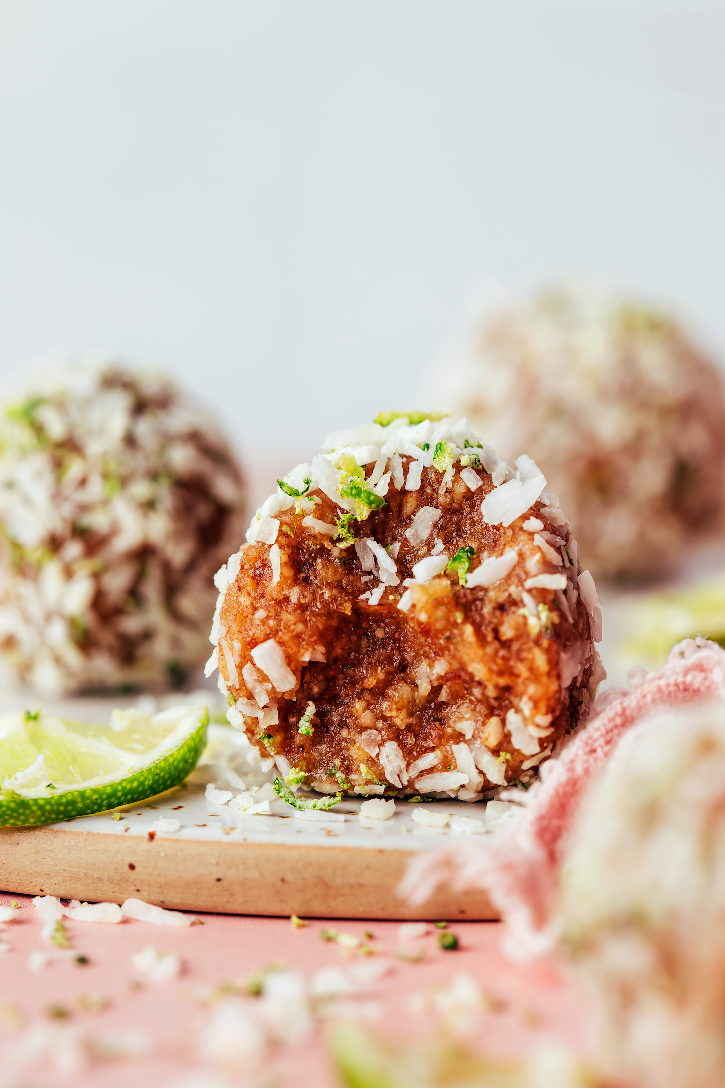 Close up photo of a partially eaten coconut lime energy bite