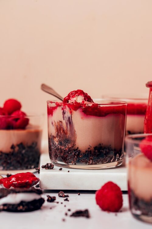 Dessert glasses filled with our No-Bake Vegan Chocolate Cheesecake recipe