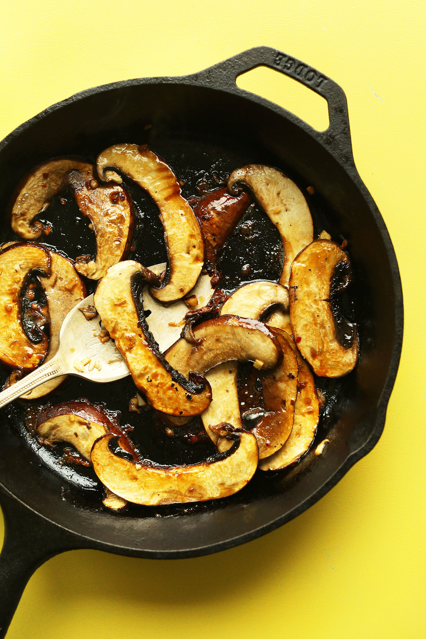 Cooking sliced portobello mushrooms in a cast-iron skillet