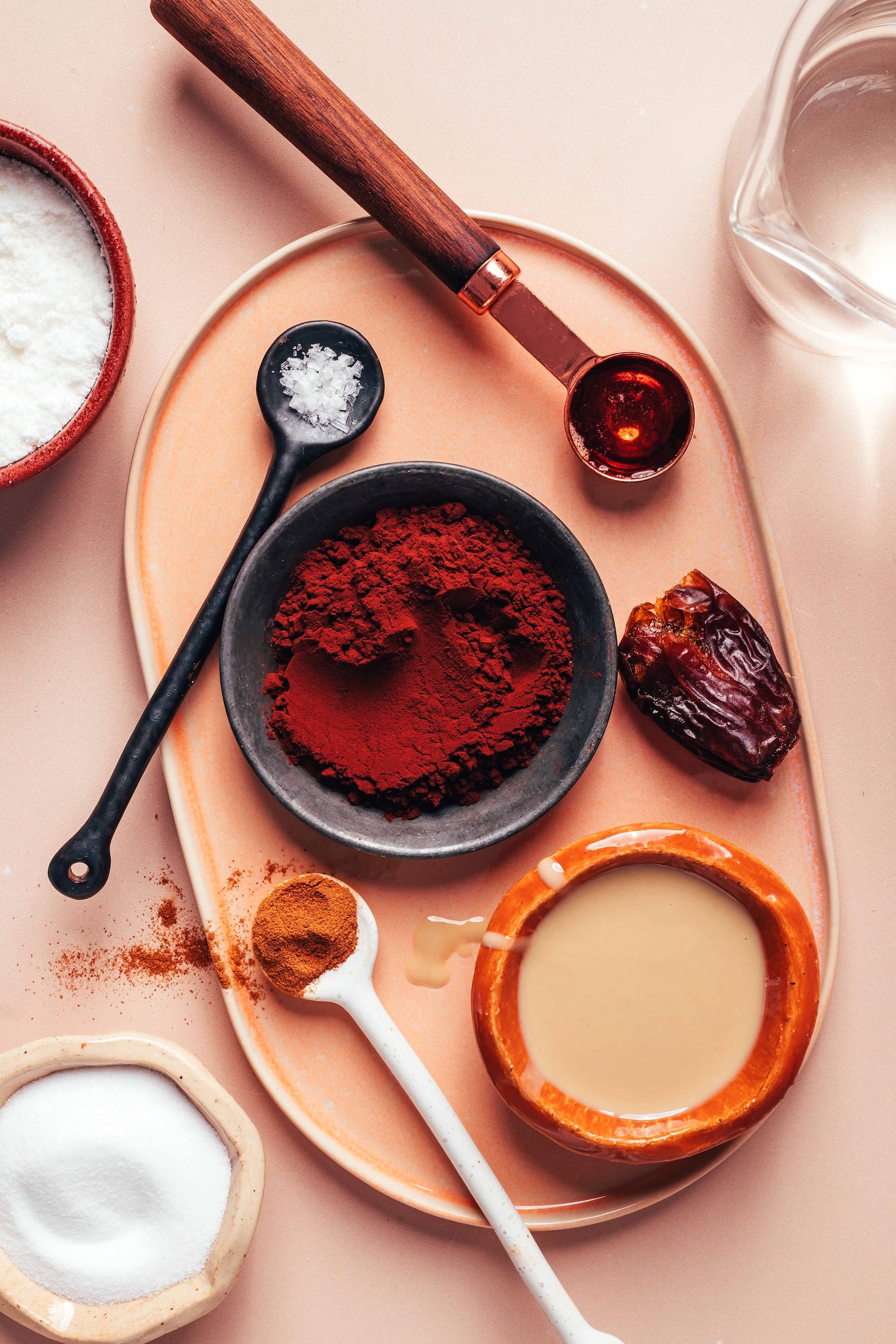 Hot water, coconut milk powder, salt, cocoa powder, cinnamon, collagen, tahini, medjool date, and maple syrup