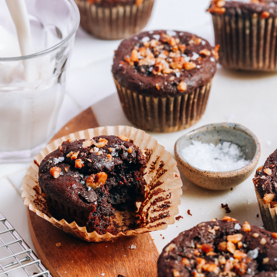 Cutting board with several vegan gluten-free banana chocolate chip muffins