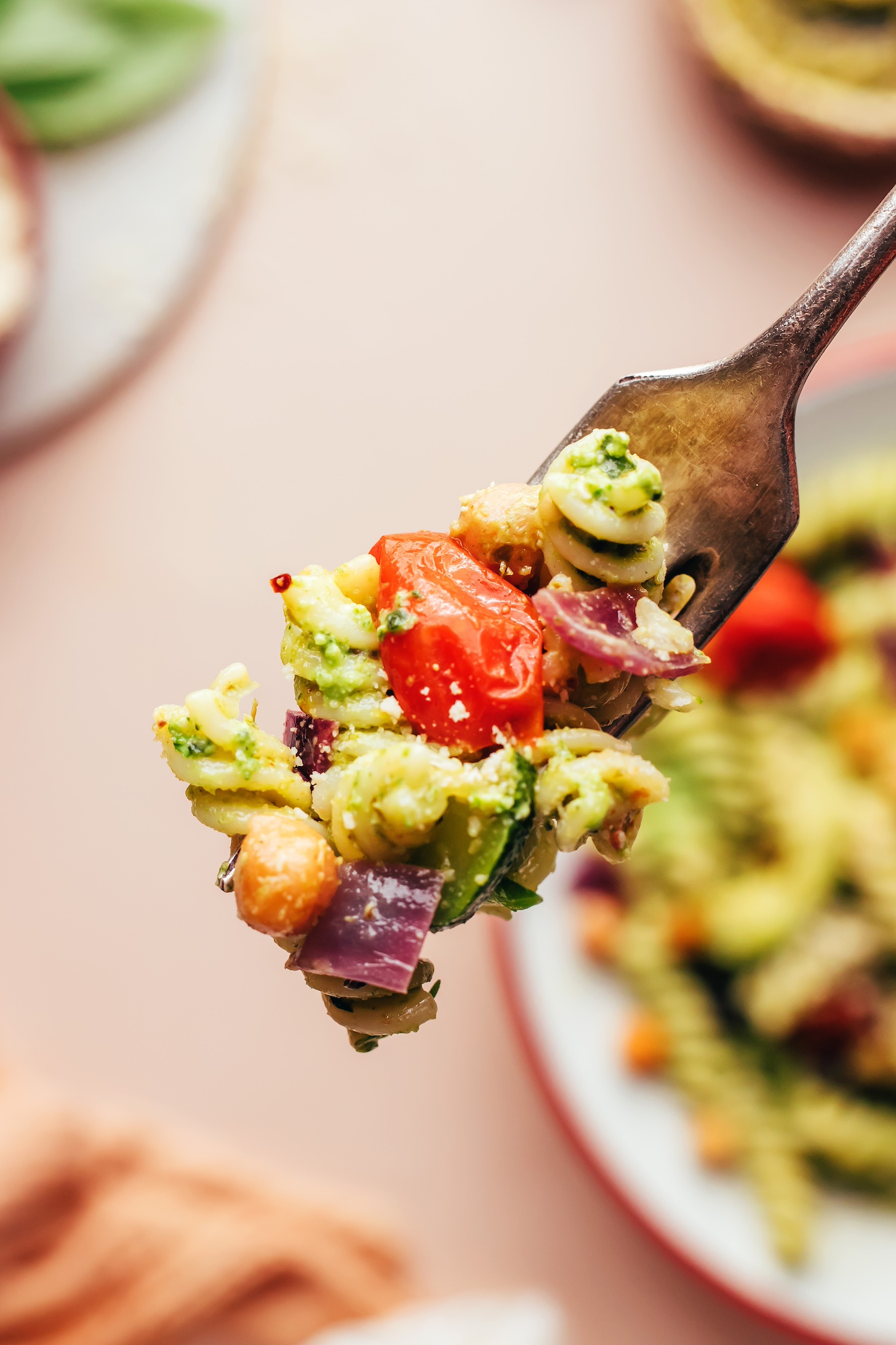 Fork wit a bite of Zucchini Pesto Pasta with Roasted Tomatoes & Chickpeas